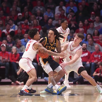 Dayton's Javon Bennett, left, and Jordan Derkack defend against East Tennessee State on Tuesday, Dec. 2, 2025, at UD Arena. David Jablonski/Staff