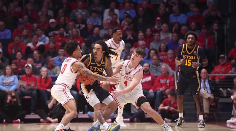 Dayton's Javon Bennett, left, and Jordan Derkack defend against East Tennessee State on Tuesday, Dec. 2, 2025, at UD Arena. David Jablonski/Staff