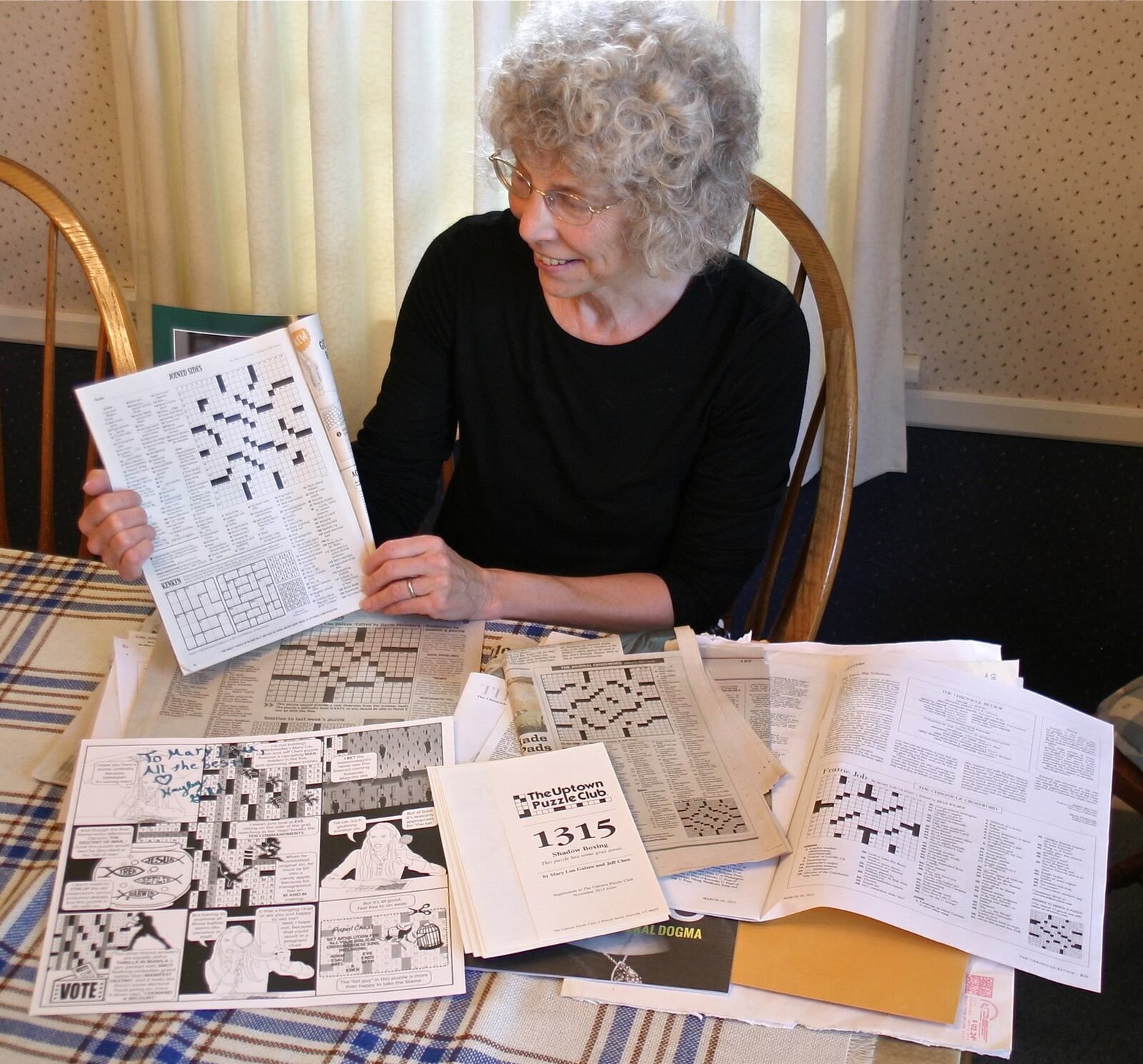 Oakwood resident Mary Lou Guizzo holds up the Sunday Magazine from the New York Times. She had her puzzles published, no easy feat. PAMELA DILLON/CONTRIBUTED