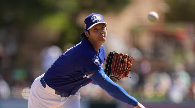 Los Angeles Dodgers starting pitcher Shohei Ohtani, of Japan, throws against the San Francisco Giants during the first inning of a spring training baseball game, Wednesday, March 18, 2026, in Phoenix. (AP Photo/Ross D. Franklin)