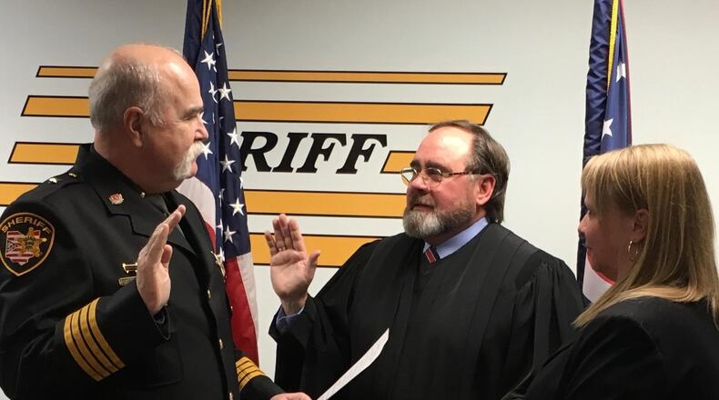 Judge Robin Piper (middle) was sworn in this month to his second term as a judge in the 12th District Court of Appeals. Administering the Oath of Office to Piper was Butler County Sheriff Richard Jones. Melissa Spurlock, former legal assistant to Piper and a current employee of the Butler County Sheriff’s Office, is shown holding the Bible during the swearing in. CONTRIBUTED