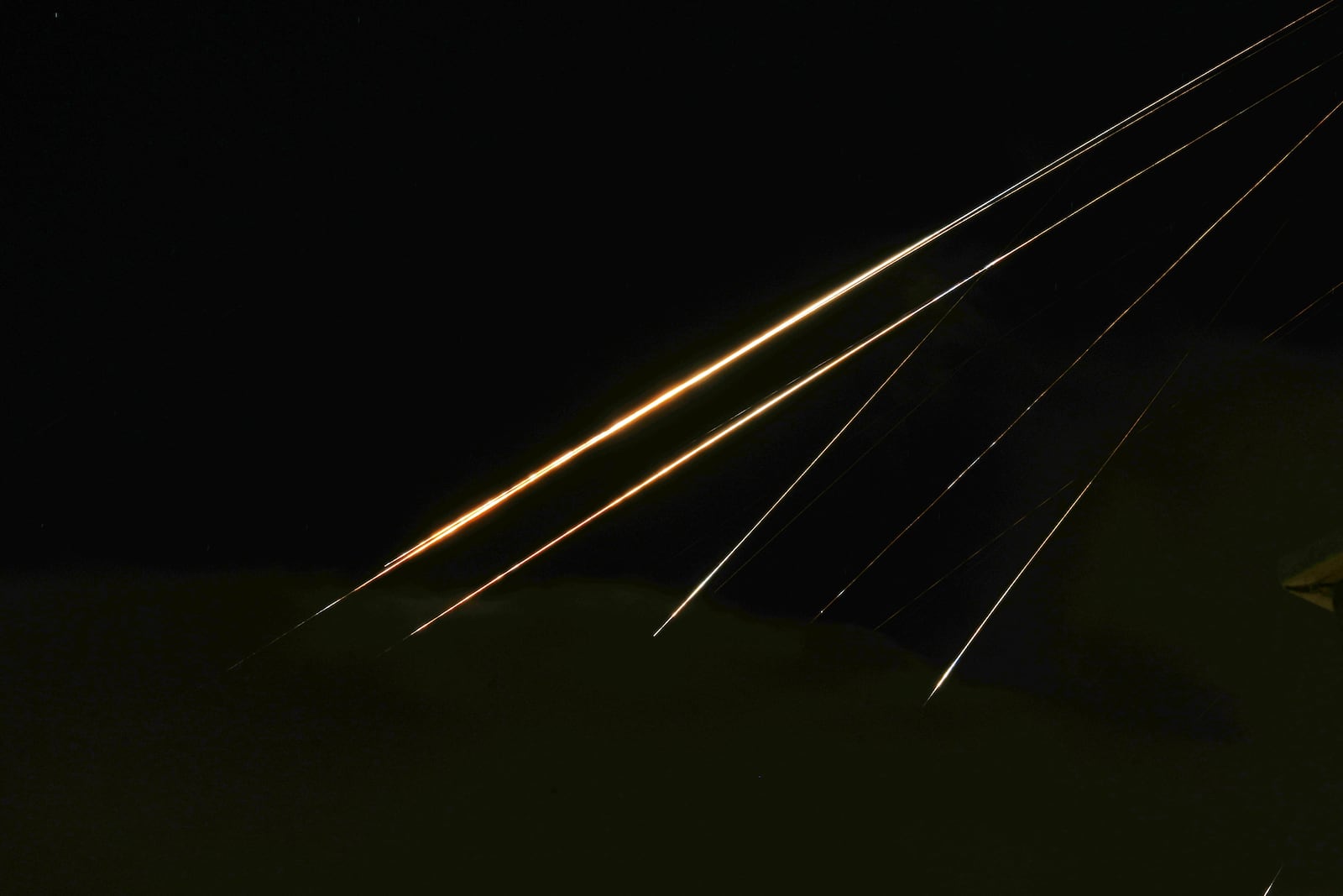 Traces of projectile illuminates the sky seen from northern Israel, Saturday, June 14, 2025. (AP Photo/Ariel Schalit)