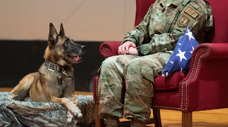 Military Working Dog Rudo and his handler, Staff Sgt. Lacey Bockman of the 88th Security Forces Squadron, are pictured at his retirement ceremony Nov. 16 in the Wright-Patterson Air Force Base theater. Rudo’s retirement plans are to move in with Bockman and her two other dogs. U.S. AIR FORCE PHOTO/R.J. ORIEZ