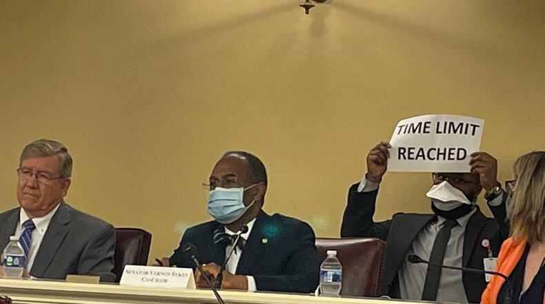 Ohio Redistricting Commission members (l-r) House Speaker Bob Cupp, R-Lima, and Sen. Vernon Sykes, D-Akron, listen to a member of the public at the commission's Sept. 14, 2021 hearing as a staff member holds up a time-limit sign.
