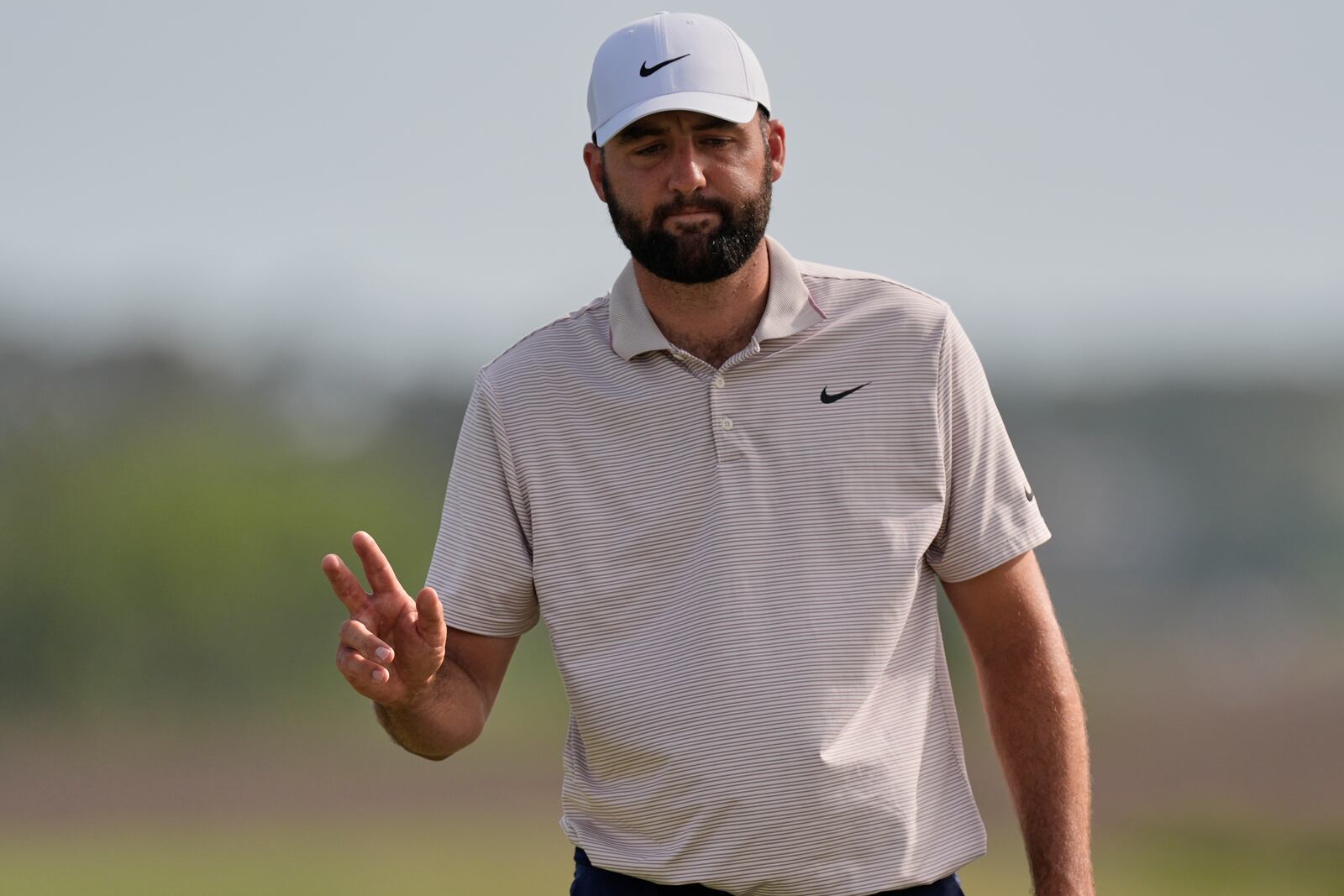 Scottie Scheffler waves to the gallery after making a putt on the 18th hole during the final round of the RBC Heritage golf tournament, Sunday, April 20, 2025, in Hilton Head Island, S.C. (AP Photo/Mike Stewart)