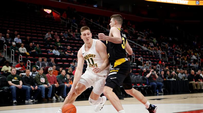 Wright State’s Loudon Love looks to drive past NKU’s Drew McDonald during the Horizon League championship game Tuesday, March 12, 2019, at Little Caesars Arena in Detroit. Brian Sevald/CONTRIBUTED