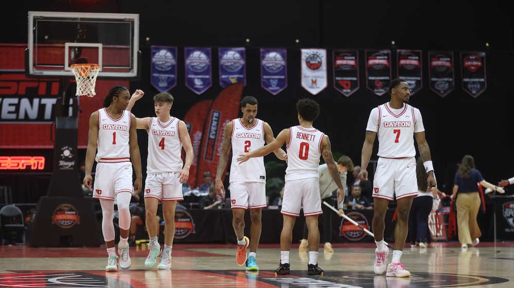 Dayton players return to the court after a timeout during a game against Georgetown on Thursday, Nov. 27, 2025, at the State Farm Field House in Kissimmee, Fla. David Jablonski/Staff