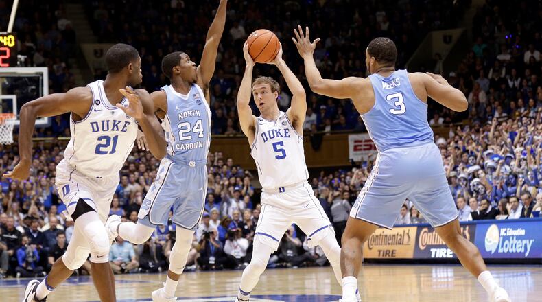 Duke’s Luke Kennard (5) looks to pass as Amile Jefferson (21) looks for the ball while North Carolina’s Kenny Williams (24) and Kennedy Meeks (3) defend during the first half of an NCAA college basketball game in Durham, N.C., Thursday, Feb. 9, 2017. (AP Photo/Gerry Broome)