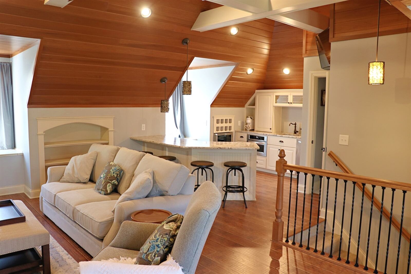 The living area has been enhanced with an apartment or recreation room above the garage.