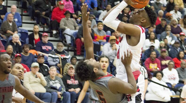 Trotwood’s Carl Blanton drives on Northridge’s Denny Moses during the Rams’ 92-44 Division II regional final victory Saturday at Trent Arena. Jeff Gilbert/CONTRIBUTED