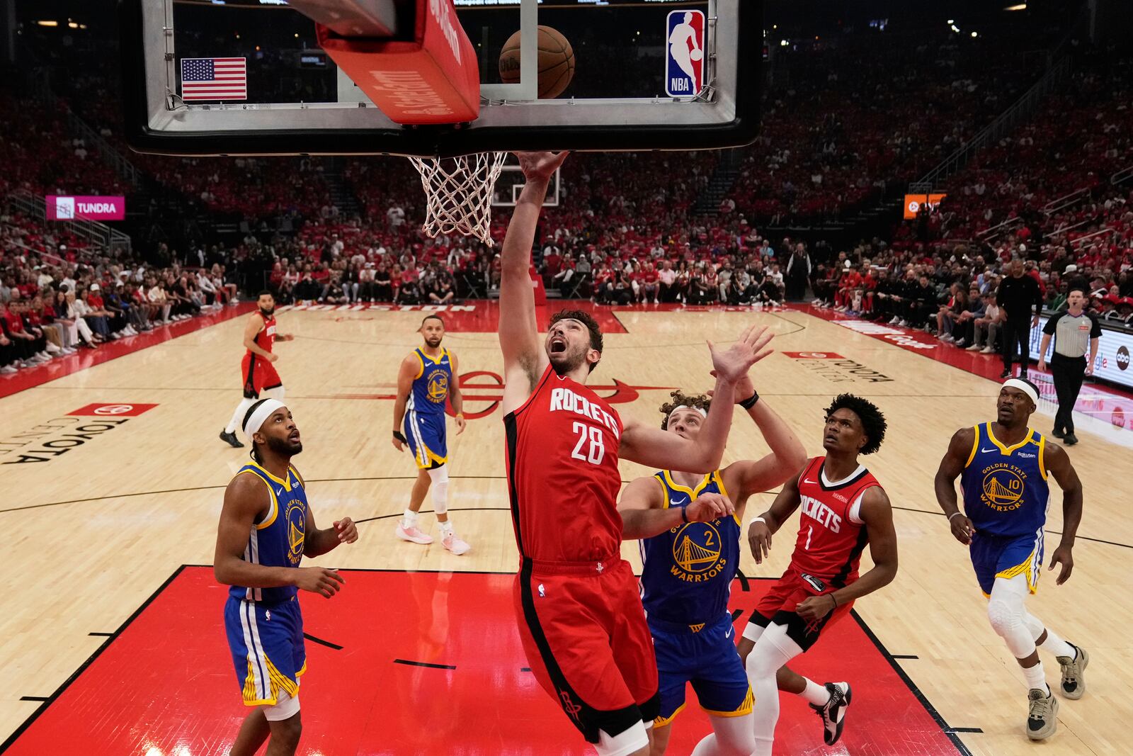 Houston Rockets center Alperen Sengun (28) shoots agasint Golden State Warriors guard Brandin Podziemski (2) during the first half of Game 1 of an NBA basketball first-round playoff series in Houston, Sunday, April 20, 2025. (AP Photo/Ashley Landis)