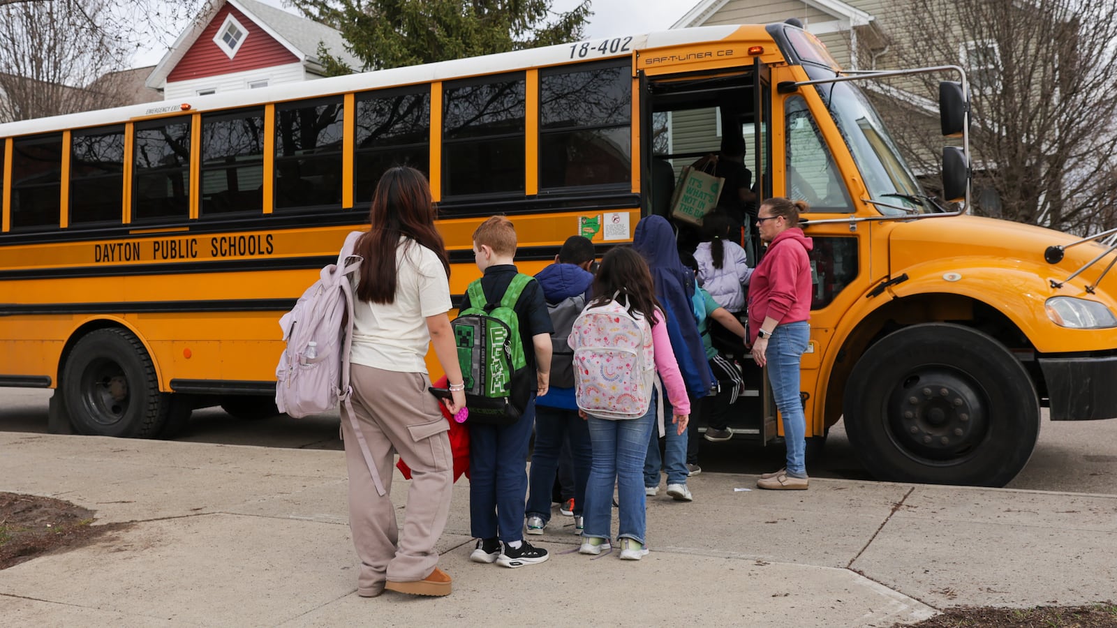 Ruskin Elementary School students board a bus on Friday, March 6 on McClure Street in Dayton. A bill in the Ohio House would provide $88 million for school transportation. BRYANT BILLING / STAFF