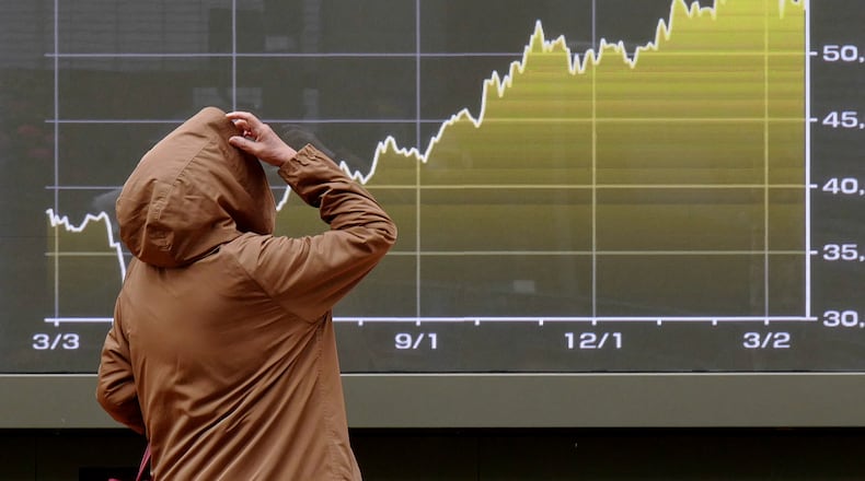 A person looks at an electronic stock board showing Japan's Nikkei index chart at a securities firm Monday, March 23, 2026, in Tokyo. (AP Photo/Eugene Hoshiko)