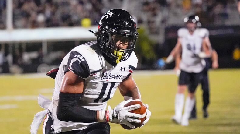 Cincinnati tight end Leonard Taylor (11) runs to the end zone for a 7-yard touchdown off a pass play against Central Florida during the second half of an NCAA college football game, Saturday, Nov. 21, 2020, in Orlando, Fla. (AP Photo/John Raoux)