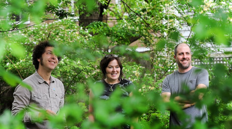 Fiver Rivers Metroparks sustainability manager Tim Pritchard , left, guides Dayton residents Glenna Jennings and Ryan Shaffer Friday, May 12, 2023, through the process of planning their own “quilt lawn.” MARSHALL GORBY\STAFF