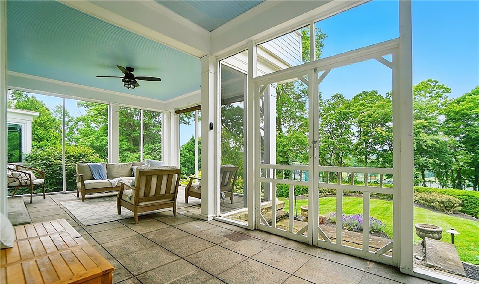 The screened in porch extends across most of the back of the home and has tile flooring, a ceiling fan and ceiling lights. CONTRIBUTED