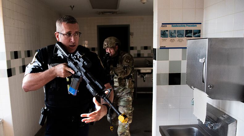 Members of the 88th Security Forces Squadron work to clear a building during an active-shooter exercise Aug. 18 at Wright-Patterson Air Force Base. The installation will go under lockdown during a similar exercise Feb. 23 to keep emergency protocol and capabilities sharp. U.S. AIR FORCE PHOTO/WESLEY FARNSWORTH