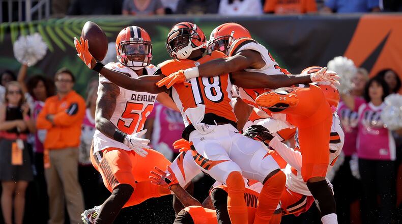 CINCINNATI, OH - OCTOBER 23: A.J. Green #18 of the Cincinnati Bengals catches a hail marry pass for a touchdown at the end of the second quarter of the game while being defended by Ibraheim Campbell #24 of the Cleveland Browns at Paul Brown Stadium on October 23, 2016 in Cincinnati, Ohio. (Photo by Andy Lyons/Getty Images)