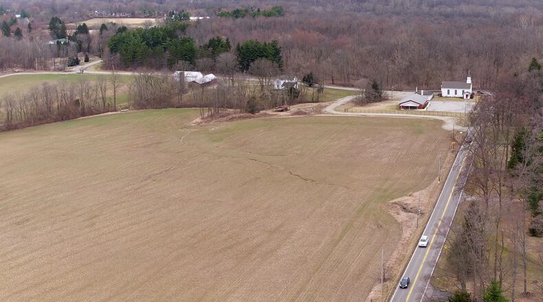 Aerial view looking north along Wilmington-Dayton Road and Conference Road in Sugarcreek Twp. Sugarcreek trustees rejected Oberer’s plan to build homes on 85 acres known as the Rammell property at this location. TY GREENLEES / STAFF