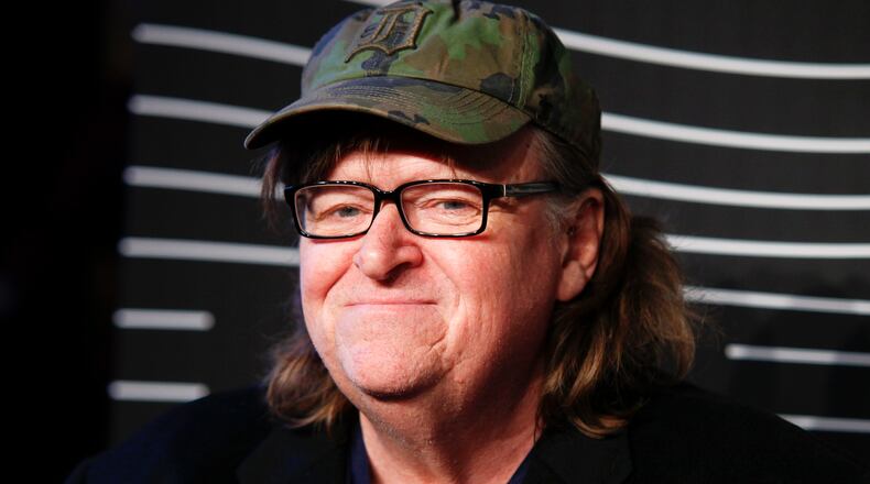 FILE - In this May 16, 2016 file photo, Michael Moore attends the 20th Annual Webby Awards at Cipriani Wall Street in New York. Moore premiered a surprise film about the U.S. presidential election on Tuesday, Oct. 18, 2016. "Michael Moore in TrumpLand" features a one-man stage show of Moore discussing the race. (Photo by Andy Kropa/Invision/AP, File)