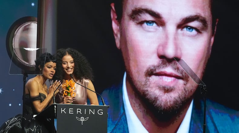 Teyana Taylor, left, and Chase Infiniti accept the desert palm achievement award on behlaf of Leonardo DiCaprio during the 37th Palm Springs International Film Festival Film Awards on Saturday, Jan. 3, 2026 at Palm Springs Convention Center in Palm Springs, Calif. (AP Photo/Chris Pizzello)