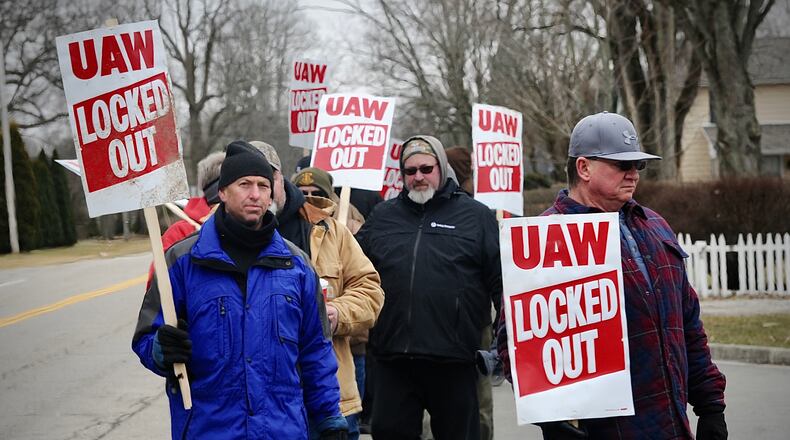 UAW employees of Collins Aerospace in Troy walk the picket line Wednesday February 23, 2022 after being locked out of the company.