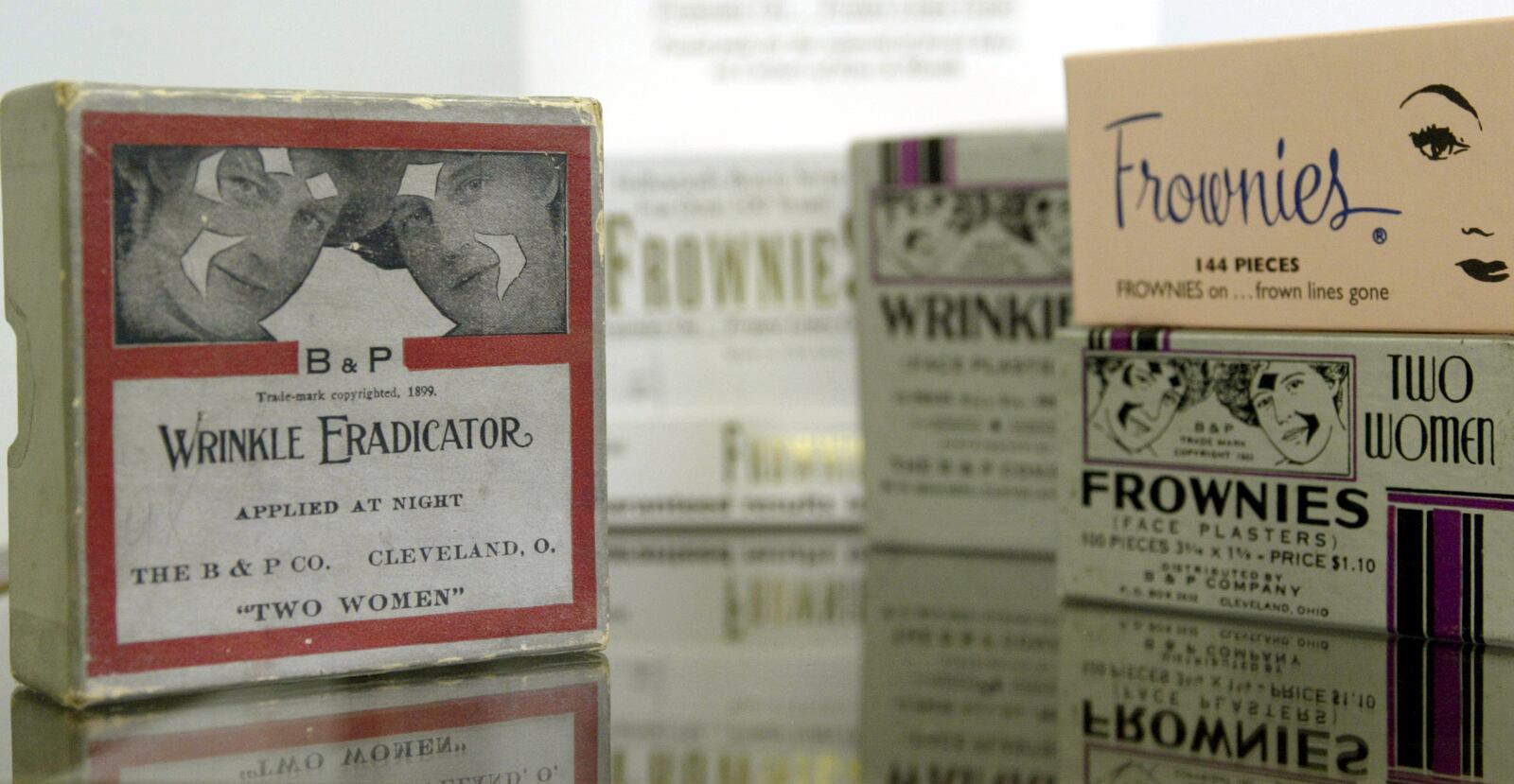 Frownies have existed since 1899. The original product was called Wrinkle Eradicator and is shown on the left. On the right are various other versions of the packaging over the years. (Skip Peterson/Dayton Daily News)
