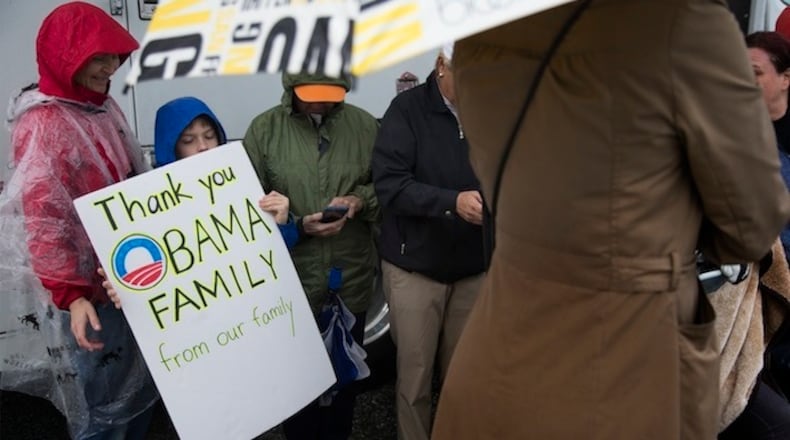 Asher Dewey, 8, carries a poster thanking former President Obama as he waits in the rain for Obama's plane to land at Palm Springs International Airport on Friday, Jan. 20, 2017, in Palm Springs, Calif. Bad weather forced his plane to be diverted to a nearby airport. (Gina Ferazzi/Los Angeles Times/TNS)
