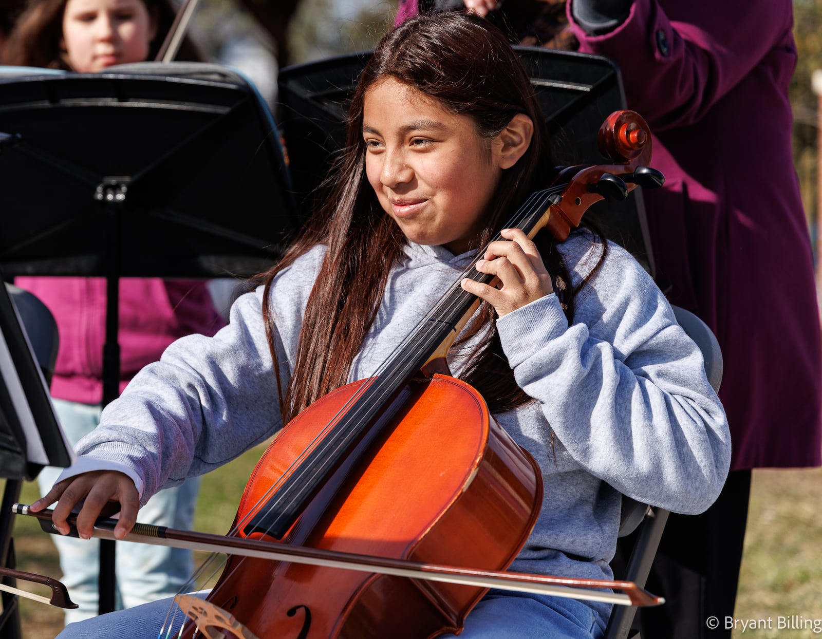 Brittany Hernandez smiles while playing the cello during a ribbon cutting ceremony for Ruskin Commons on Wednesday, Nov. 12 in Dayton. Hernandez plays with "Q the Music," a group of students from Ruskin Elementary School. BRYANT BILLING/STAFF
