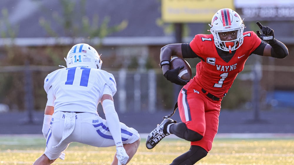 Wayne junior receiver Jamier Averette-Brown (right) tries to avoid Springboro's rice Markoff during a Greater Western Ohio Conference game on Friday, Sept. 12 at Heidkamp Stadium. Brown, an Ohio State recruit, had over 250 all-purpose yards and scored two touchdowns. BRYANT BILLING / STAFF