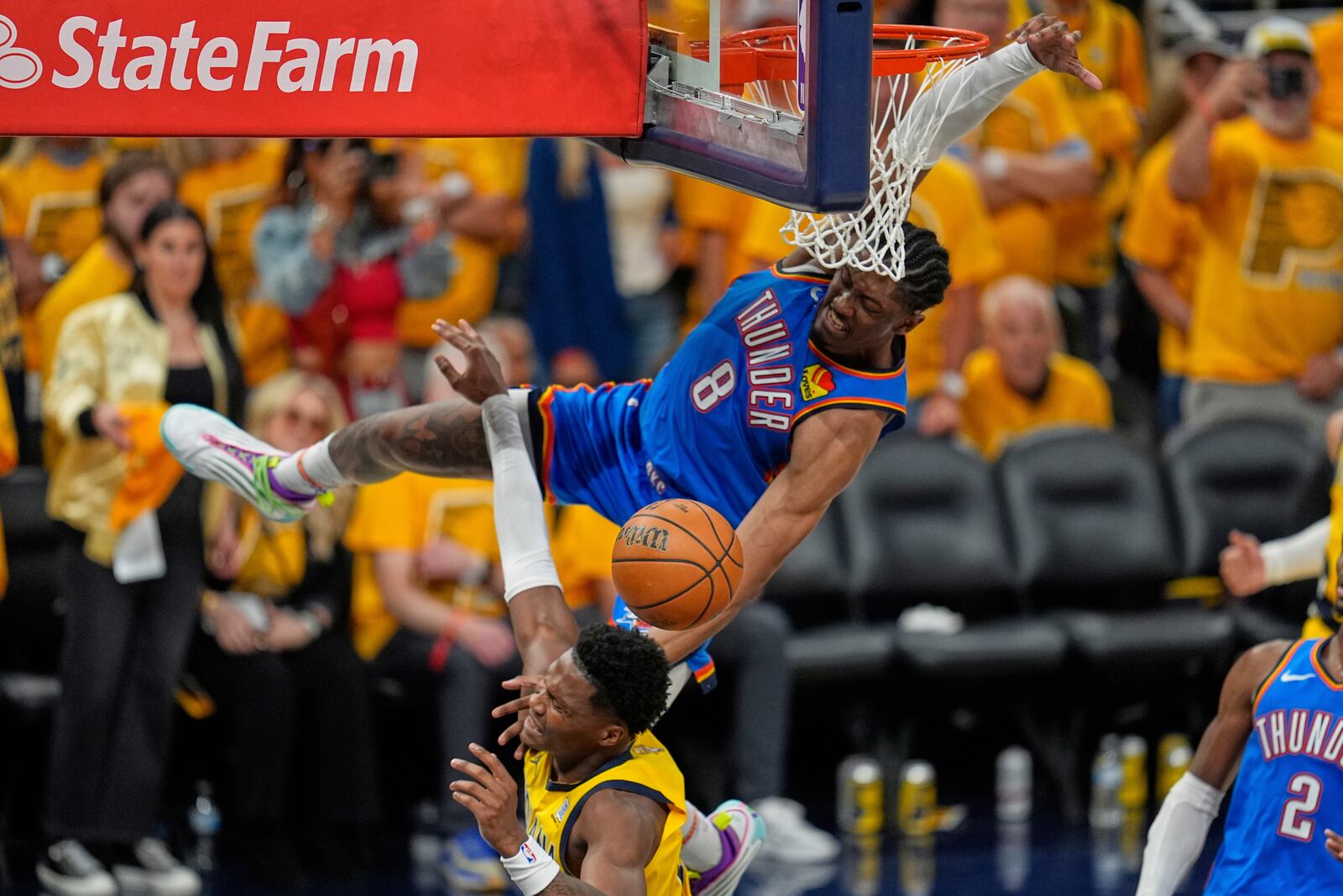 Indiana Pacers guard Bennedict Mathurin is fouled by Oklahoma City Thunder forward Jalen Williams (8) during the second half of Game 4 of the NBA Finals basketball series, Friday, June 13, 2025, in Indianapolis. (AP Photo/Abbie Parr)