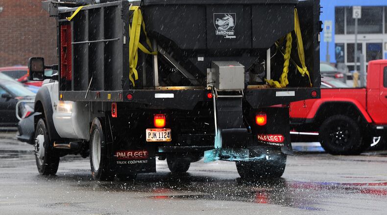 A salt truck works the parking lot at the Walmart on Miller Lane Monday, Jan. 25, 2021. A Winter Weather Advisory was in effect as freezing rain, and a wintry mix moved into area.