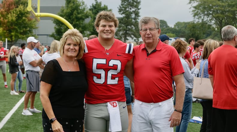Dayton offensive linemen Brian Stevens, center, stands with his mom Terri and dad Tom at UD football media day on Sunday, Aug. 21, 2022, at Jerry Von Mahr Practice Field. David Jablonski/Staff