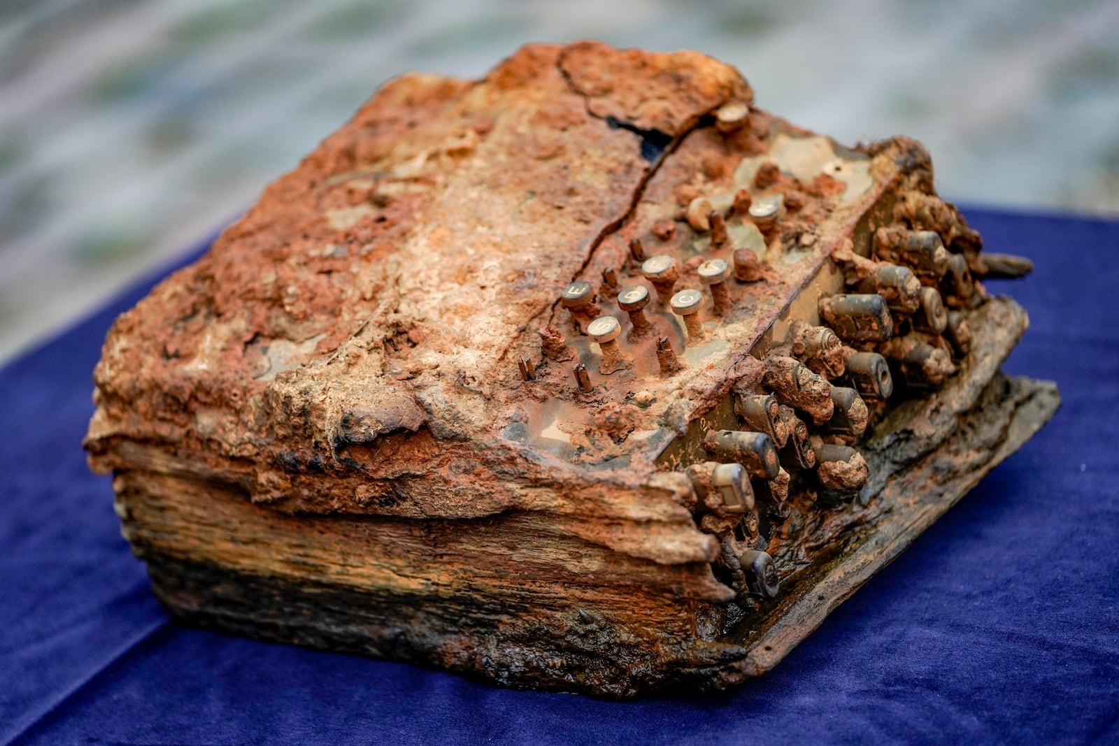 File---File picture taken Dec.4, 2020 shows an Enigma cipher machine found in the Baltic Sea in front of the archaeological office of German federal state Schleswig-Holstein in Schleswig, Germany. The machine was handed over to the office after it was discovered in the Baltic Sea in November. (Axel Heimken/dpa via AP, File)