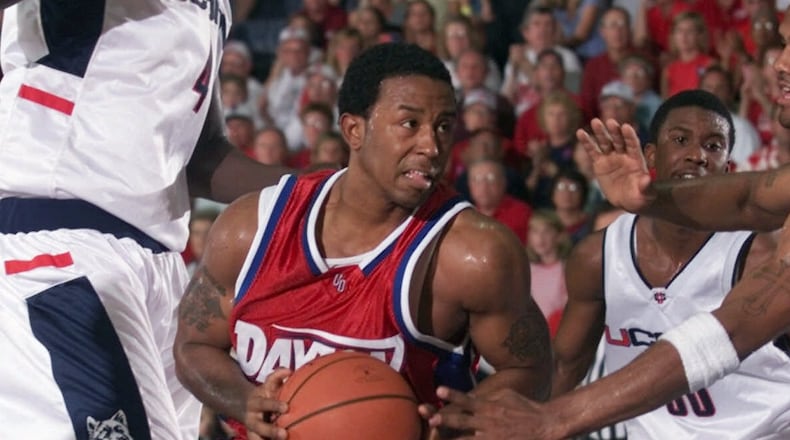 Dayton's David Morris is stopped by Connecticut's Nate Green as he drives the lane after getting past Ajou Deng, left, of Connecticut in the first half of an opening round game of the Maui Invitational in Lahaina, Hawaii Monday, Nov. 20, 2000. (AP Photo/Michael Conroy)