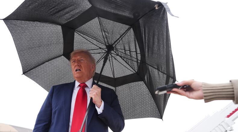 President Donald Trump speaks with reporters before boarding Air Force One, Sunday, Oct. 12, 2025, at Joint Base Andrews, Md., as he heads to the Middle East. (AP Photo/Evan Vucci)