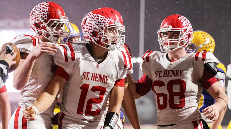 St. Henry senior quarterback Charlie Werling celebrates after a short touchdown run in the third quarter of the Division VII, Region 28 championship game on Friday, Nov. 21 at Mercy Health/Wapak VFW Field in Wapakoneta. Werling scored four TDs to help the Redskins win 24-7 and snap a 76-game winning streak by the Flyers. BRYANT BILLING/STAFF