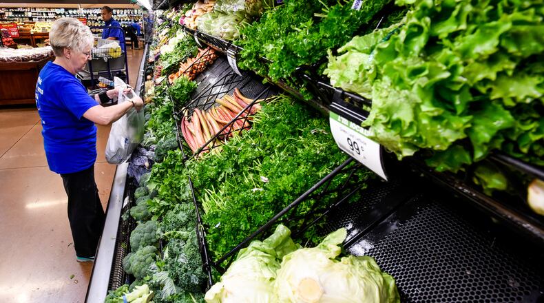 A Kroger worker collects an online grocery order for Clicklist in Liberty Twp. NICK GRAHAM/STAFF