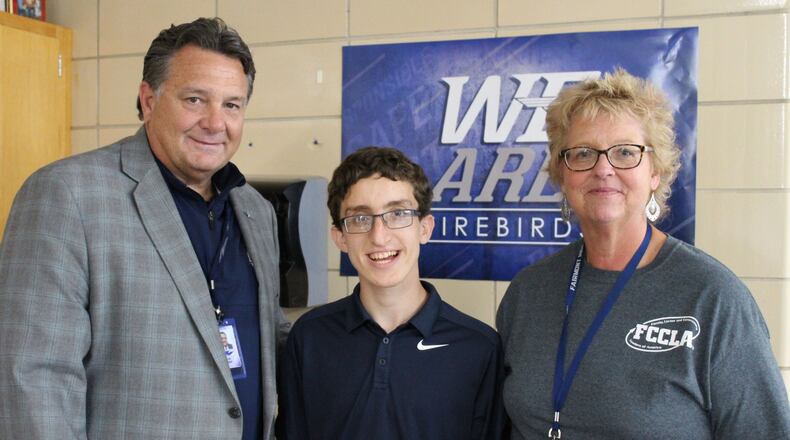 Scott Inskeep, superintendent of the Kettering Schools, joins Theodore Hale and family and consumer science teacher Ruth Budd for the 2017 Fall Hallway Harvest. CONTRIBUTED