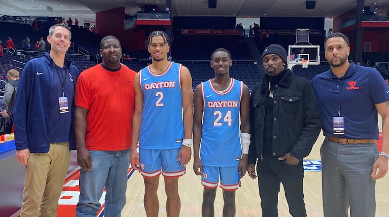 Members of the 2002-03 Dayton Flyers pose for photos with current Flyers on Friday, Nov. 11, 2022, at UD Arena. Pictured from left to right are: Keith Waleskowski; Nate Green; Toumani Camara; Kobe Elvis; Ramod Marshall; and Brooks Hall. Contributed photo