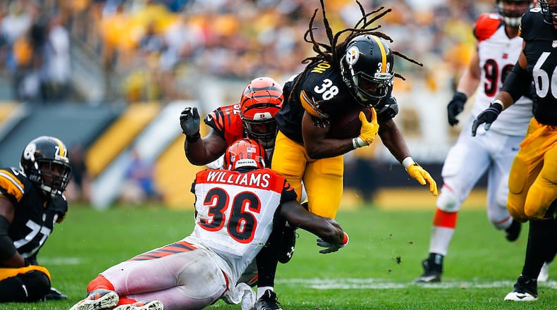 PITTSBURGH, PA - SEPTEMBER 18: Daryl Richardson #38 of the Pittsburgh Steelers is tackled by Shawn Williams #36 of the Cincinnati Bengals in the first half during the game at Heinz Field on September 18, 2016 in Pittsburgh, Pennsylvania. (Photo by Justin K. Aller/Getty Images)