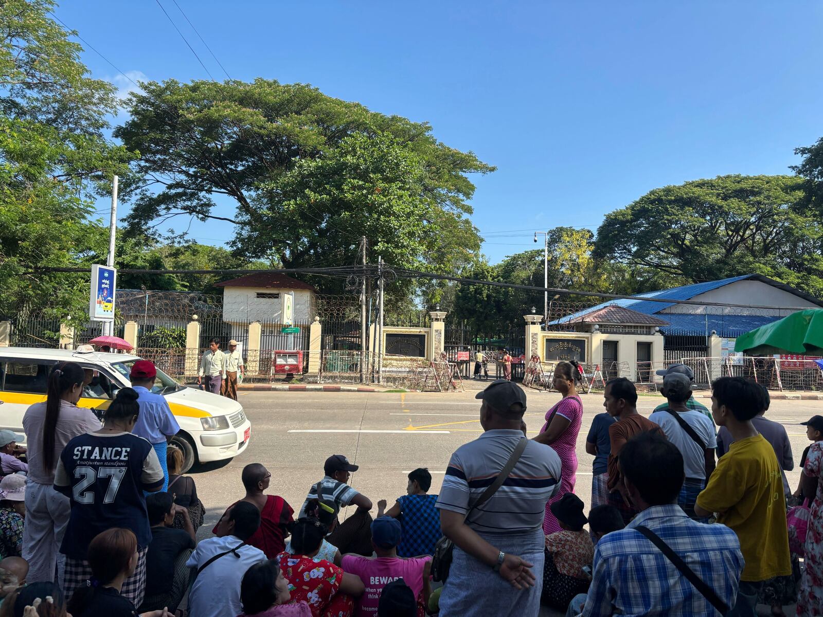 Family members and colleagues wait to welcome released prisoners outside the main gate of Insein prison during the country's traditional New Year day on Thursday, April 17, 2025, in Yangon, Myanmar. (AP Photo/Thein Zaw)