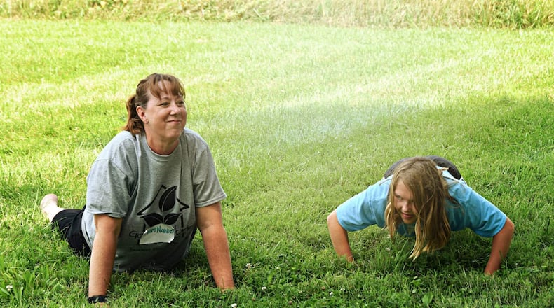 Nancy Bernotaitis, does yoga with a camper at Good Works Farm. CONTRIBUTED