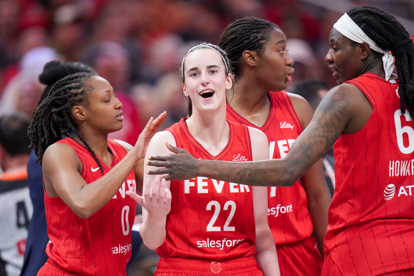 Indiana Fever guard Caitlin Clark (22) is ushered back to the bench area by teammates after being called for a flagrant foul on Chicago Sky forward Angel Reese during the second half an WNBA basketball game in Indianapolis, Saturday, May 17, 2025. (AP Photo/AJ Mast)