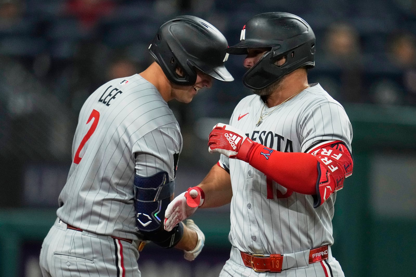 Minnesota Twins first baseman Ty France, right, is congratulated by teammate Brooks Lee (2) after hitting a home run in the fifth inning of a baseball game against the Cleveland Guardians in Cleveland, Tuesday, April 29, 2025. (AP Photo/Sue Ogrocki)