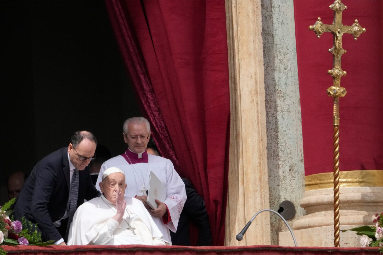 Pope Francis bestows the Urbi et Orbi (Latin for to the city and to the world) blessing from the central lodge of St. Peter's Basilica at the end of the Easter mass presided over by Cardinal Angelo Comastri in St. Peter's Square at the Vatican Sunday, April 20, 2025. (AP Photo/Gregorio Borgia)