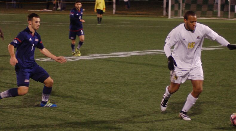 AJ Paterson (16) looks to turn the ball up the pitch as UIC’s Max Todd moves in to apply pressure during first half action of the Horizon League men’s soccer championship game Saturday night at Alumni Field. John Cummings/Contributed photo
