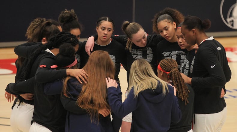Dayton huddles before a game against Saint Louis on Saturday, Feb. 20, 2021, at UD Arena. David Jablonski/Staff