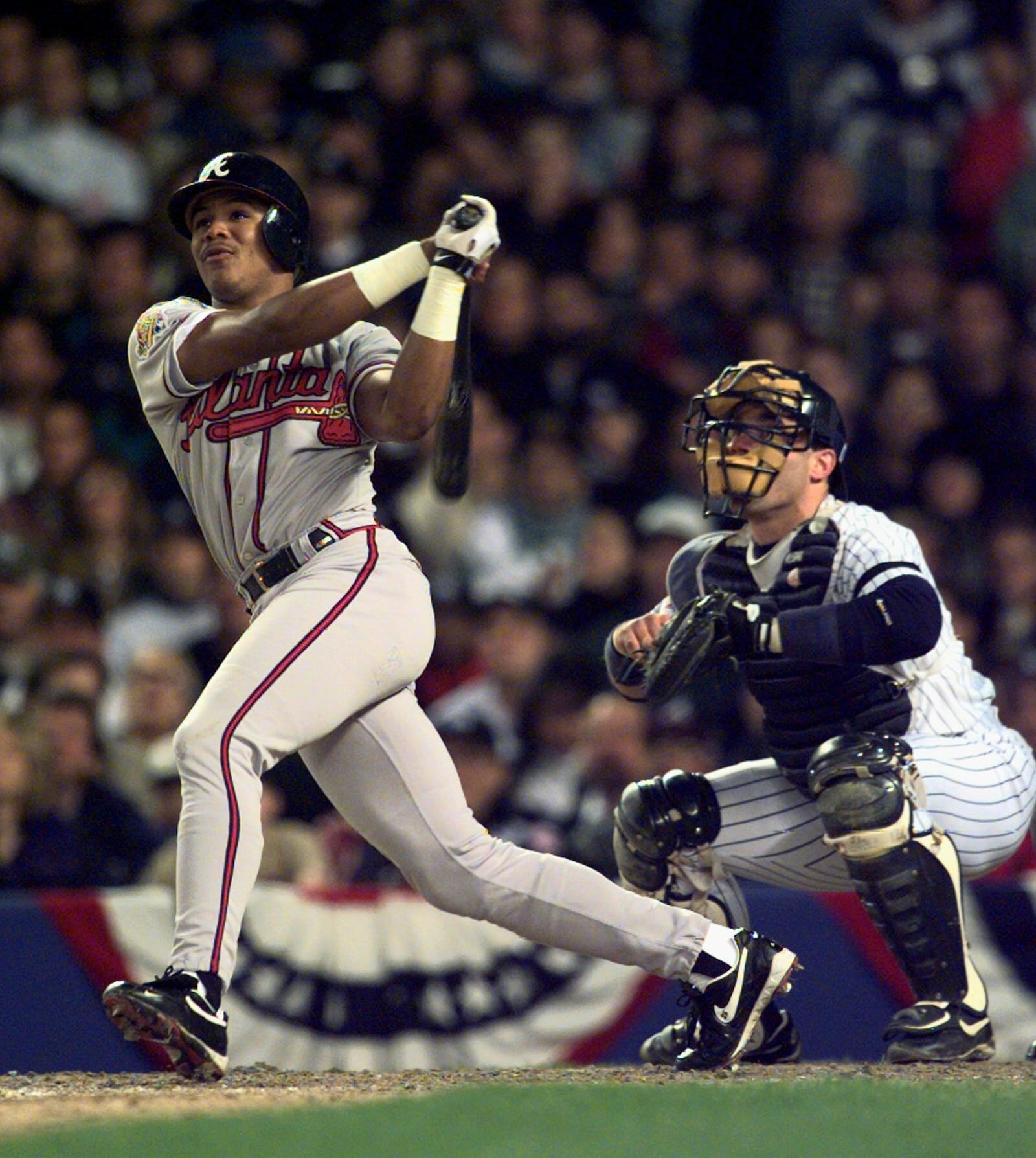 FILE - Atlanta Braves' Andruw Jones watches his home run in front of New York Yankees' catcher Jim Leyritz in the second inning of the World Series on Oct. 20, 1996, in New York. (AP Photo/Mark Lennihan, File)
