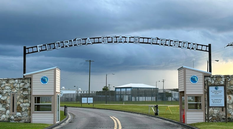 FILE - Clouds hover over the entrance of the Florida State Prison in Starke, Fla., Aug. 3, 2023. (AP Photo/Curt Anderson, file)